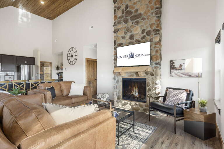 Living Room With Fireplace And Seating Area In Vacation Rental