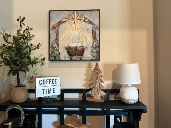 Tabletop Tableau Featuring Framed Artwork, Light Lamp, And Foliage Tabletop Tableau Featuring Framed Artwork, Light Lamp, And Foliage