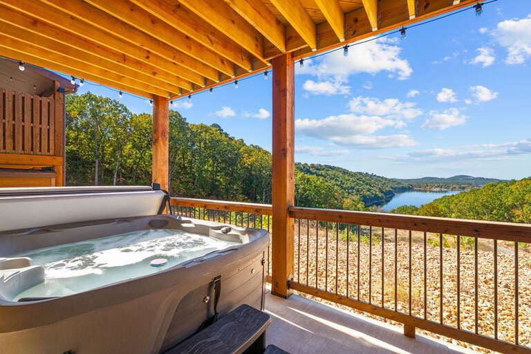Jacuzzi On A Balcony Overlooking A Blue Lake And Lush Hills