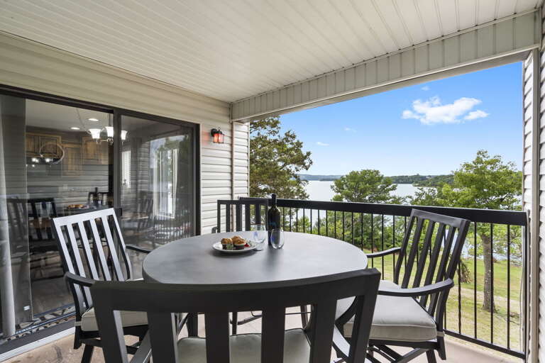 Balcony With Table And Chairs Overlooking Lake