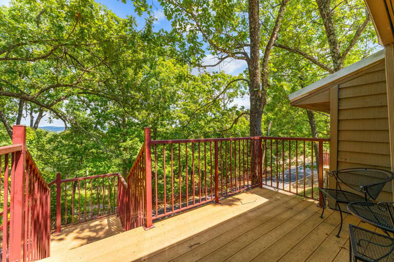 Leafy Lakeside Deck With Red Railings