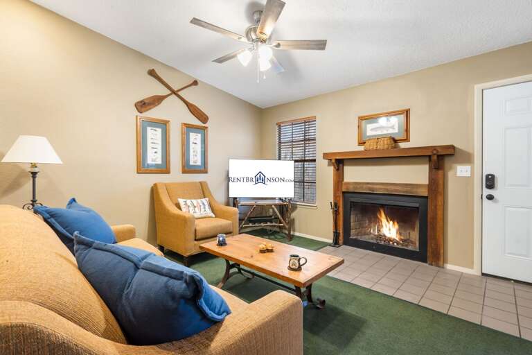 Living Space With Luminous Lighting, Lush Sofas, And A Lit Fireplace