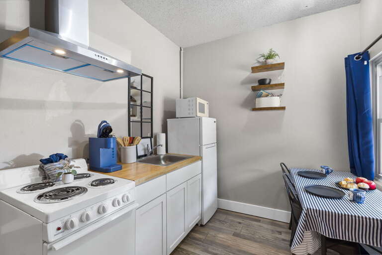 Compact Kitchen Scene With Striped Tablecloth And Blue Accents