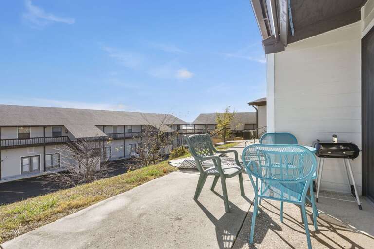 Balcony Bearing Blue Bistro Set, Building Backdrop, Bright Day