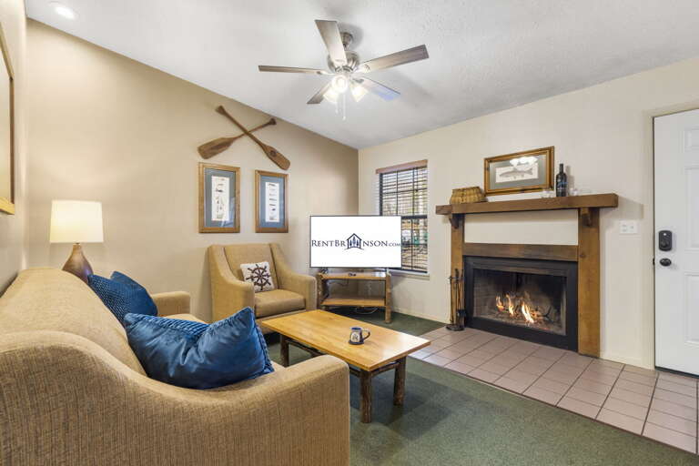 Living Room With Fireplace, Plush Sofas, And Television