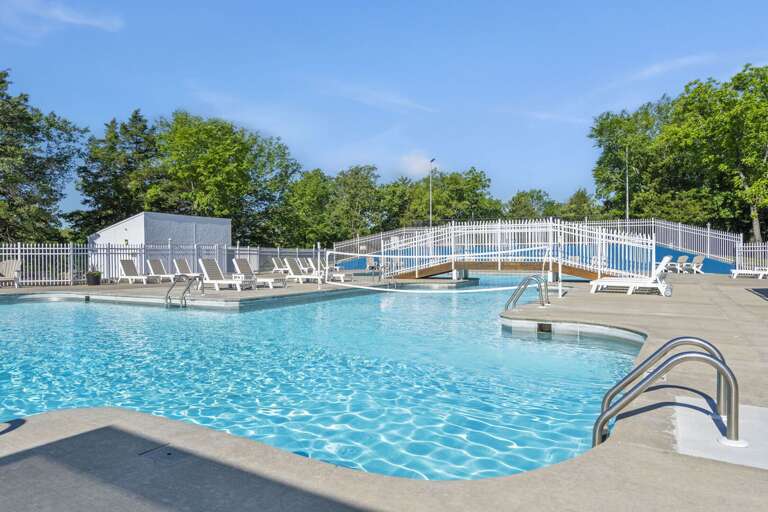 Sun-splashed Swimming Spot With Breezy Blue Waters And Loungers