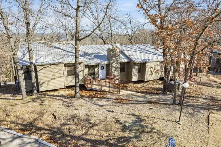 Rustic Rental Surrounded By Bare Branches, Bathed In Sunlight