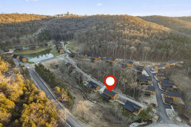Aerial Perspective Of A Hilly Residential Area With Roofed Buildings Amid Bare Trees Aerial Perspective Of A Hilly Residential Area With Roofed Buildings Amid Bare Trees