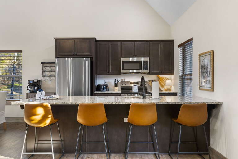 Kitchen With Counter Seating In Vacation Rental