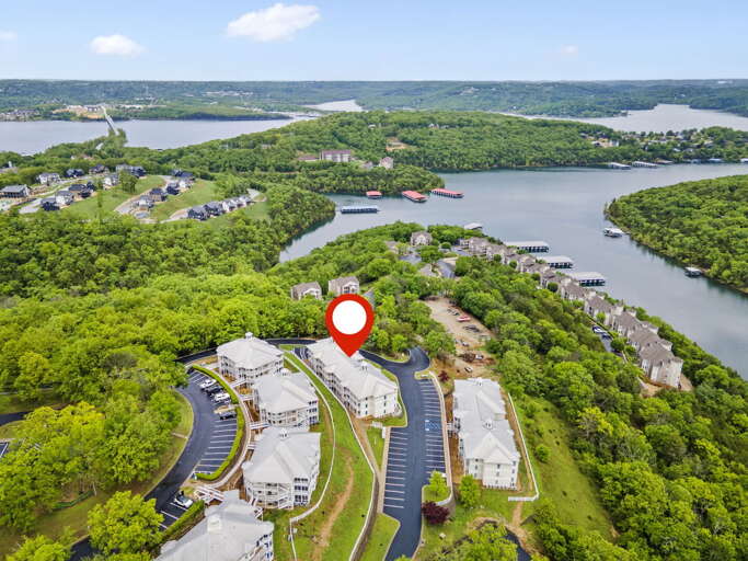 Aerial View Of Lakeside Vacation Rental Surrounded By Greenery