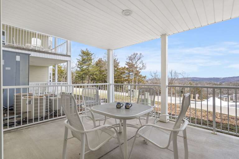 Balcony View With Table And Chairs Overlooking Scenic Landscape
