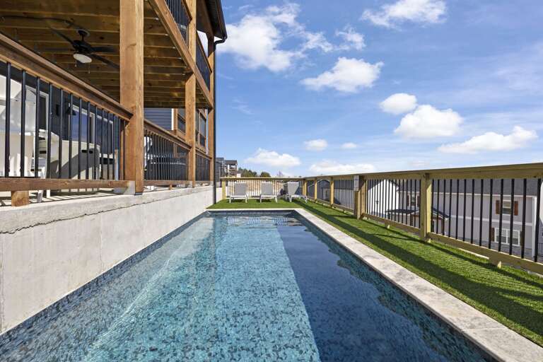 Blue Pool Beside Building Under Bright Blue Sky