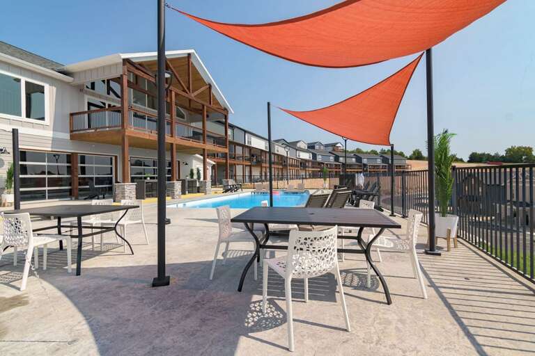 Sun-sheltered Seating By Serene Swimming Space, Structured Building Backdrop