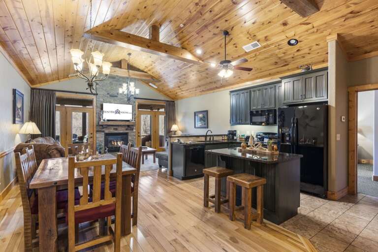 Wood-lined Interior With Beams, Spacious Kitchen, And Dining Area