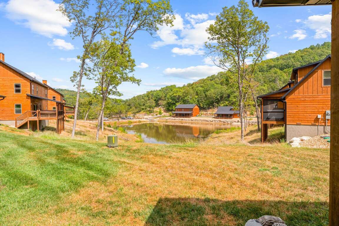 Cabins Clustered By A Calm, Clear Pond