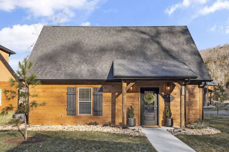 Wooden House With Sharp Shingles, Slender Shutters, Sunlit Setting