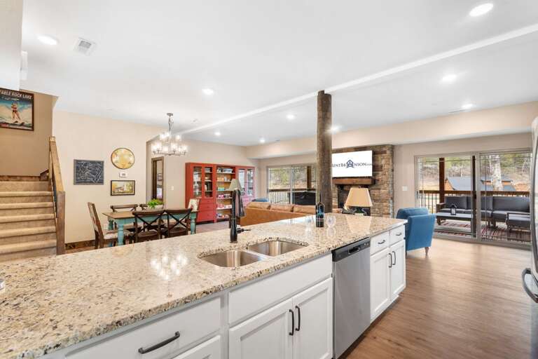 Interior View Showing Kitchen With Island Connecting To Dining Space, Visible Living Area
