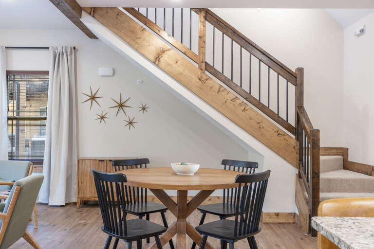 Interior Space Showcasing Stairs, Dining Table, Star Decor On Wall
