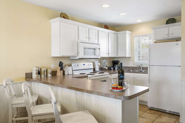 Bright Kitchen, White Cabinetry, Sleek Surfaces, Spacious Seating