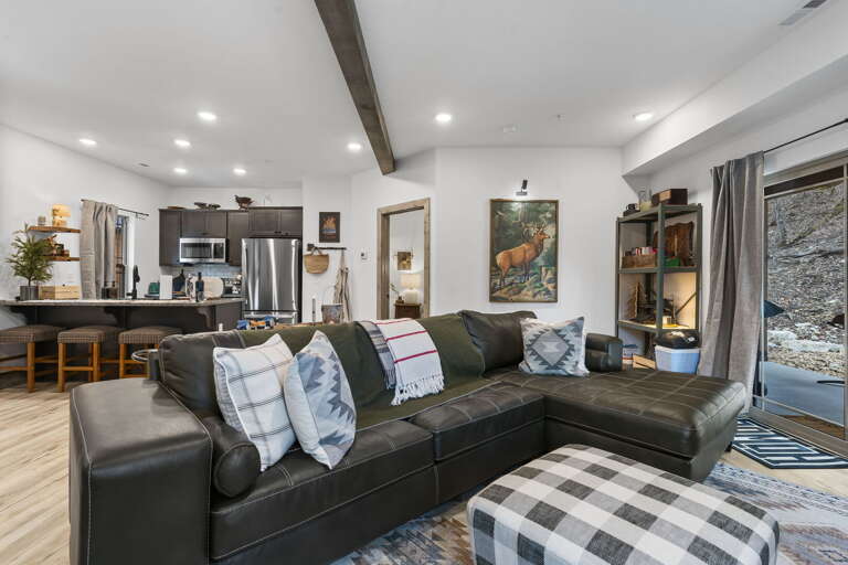 Spacious Living Space With Large Sofa, Open Kitchen, Gleaming Floors