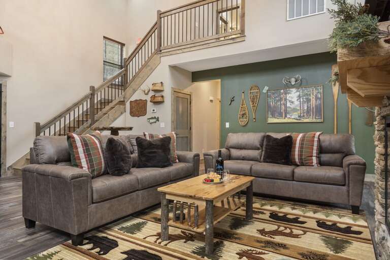 Rustic Rental Room With Wooden Staircase And Plush Sofas