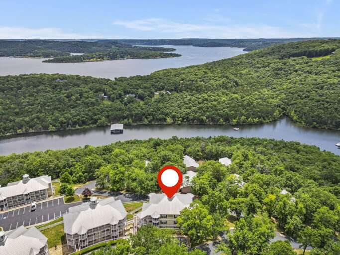 Aerial View Of A Lakeside Lodging Nestled In Lush Greenery