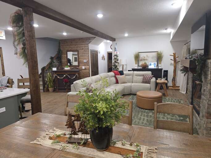 Spacious, Styled Space With Sectional Sofa And Exposed Brick