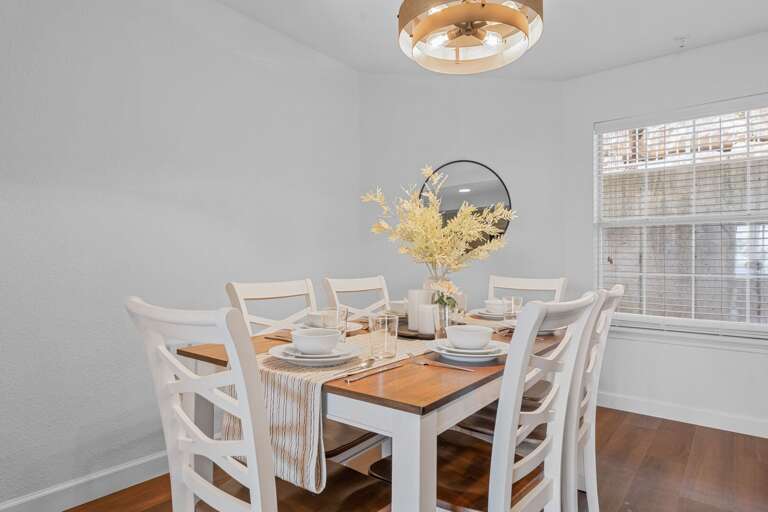 Dining Room Display: White Chairs, Wooden Table, Subdued Setting