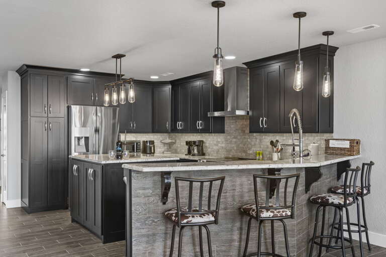 Sleek Kitchen Space Showcasing Shiny Surfaces And Stylish Stools