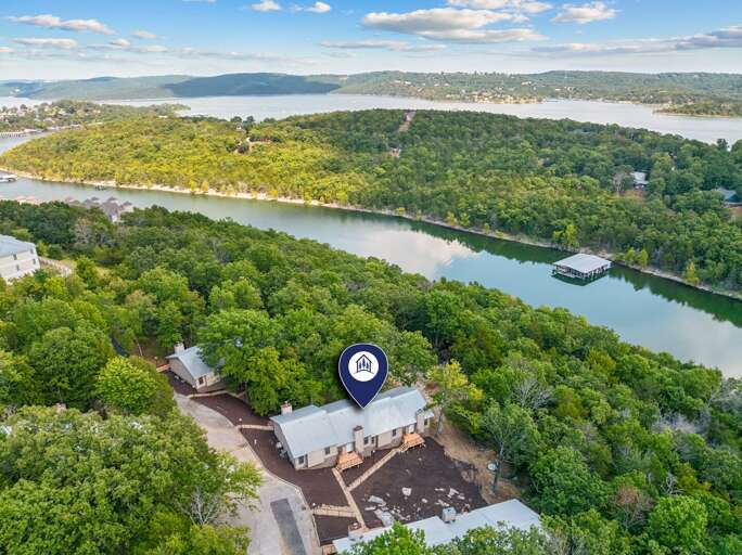 Aerial View Of Riverside Building Nestled In Lush Foliage