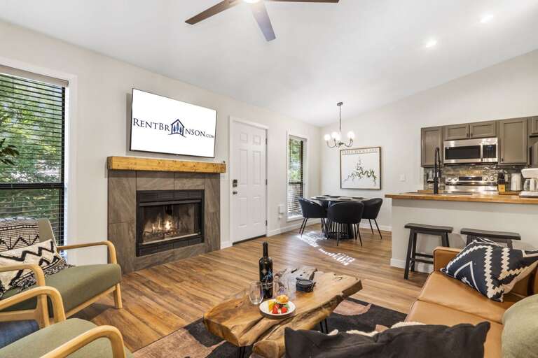 Brightly Lit Living Space With Fireplace, Adjacent Kitchen, Inviting Interiors