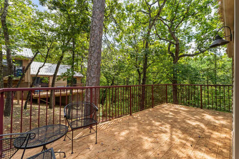 Rustic Railing On Sunlit Balcony Beside Lush Forest