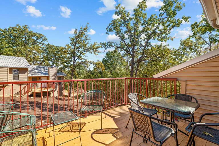 Sunny Balcony With Trees, Tables, And Chairs