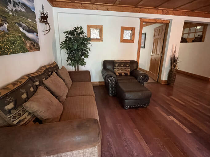 Entryway sofa and chair with door to primary queen bedroom
