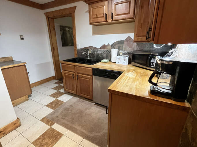 Kitchen with storage and stainless dishwasher