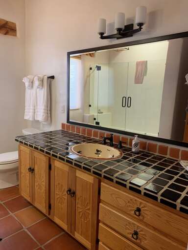 Spacious second bathroom offers double vanity, tub and shower.