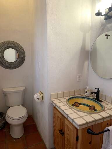 A half bathroom is provided for added convenience near the game room.