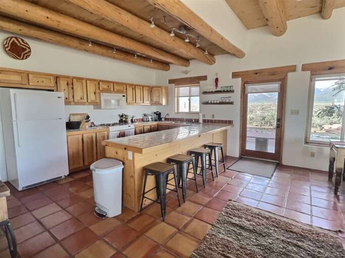 Kitchen Breakfast Bar and Exit to Porch/Patio