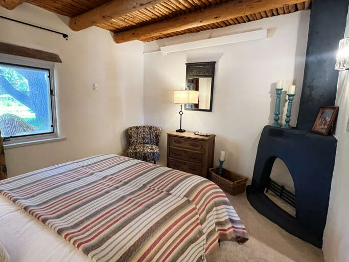 Queen bedroom with decorative fireplace