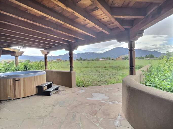 Hot tub covered porch at one end of the yard