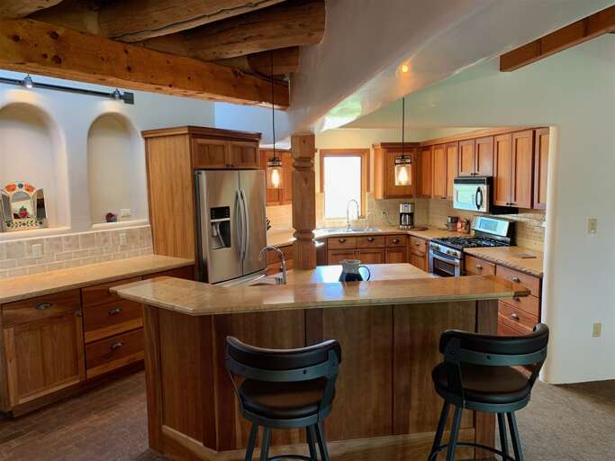 Looking across kitchen island into kitchen