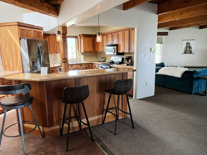 View from the dining area into the kitchen and living area