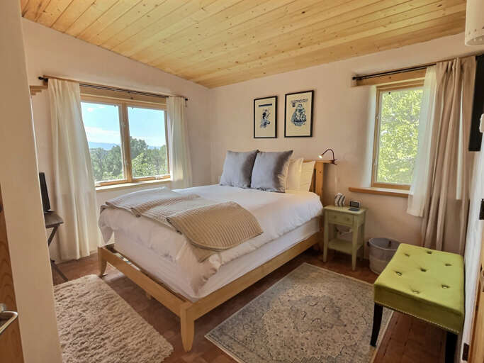 Luxurious queen bedroom with lots of light