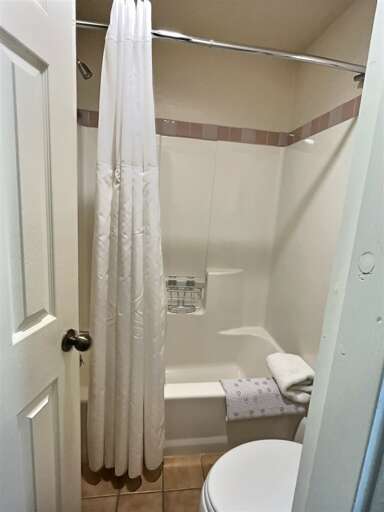 Bathroom with shower-tub combo.