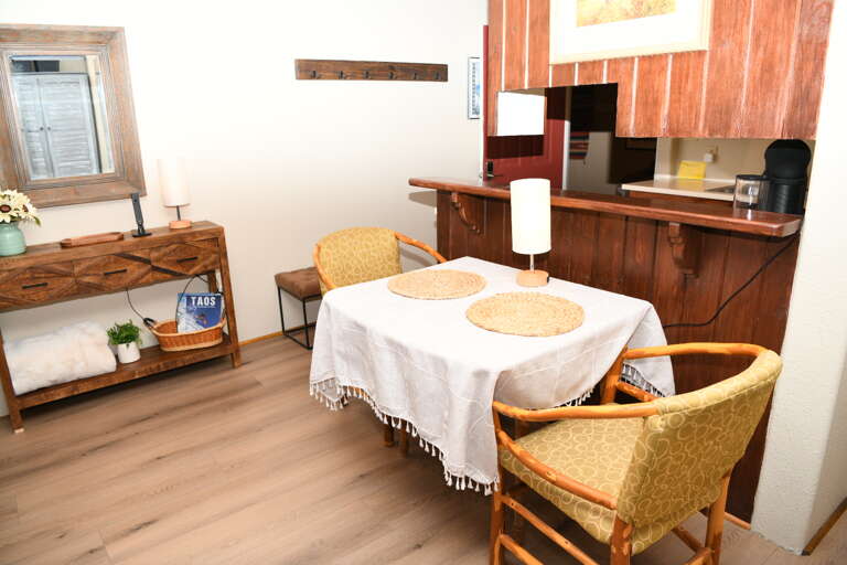 Dining table situated between the kitchen and living area.