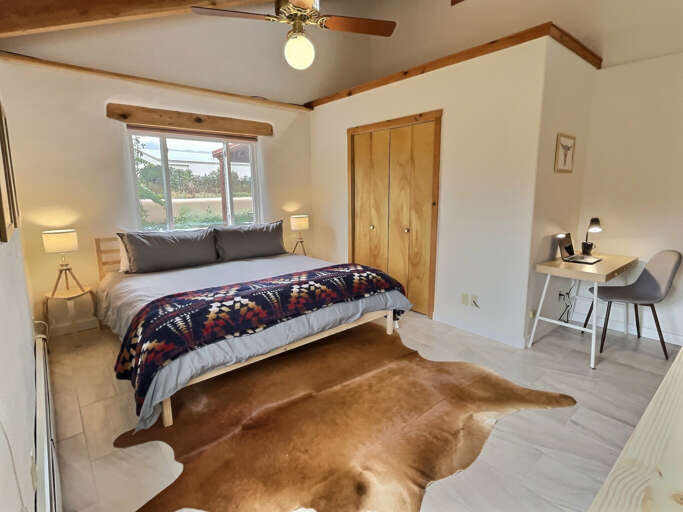 King bedroom with mountain views and dedicated workspace