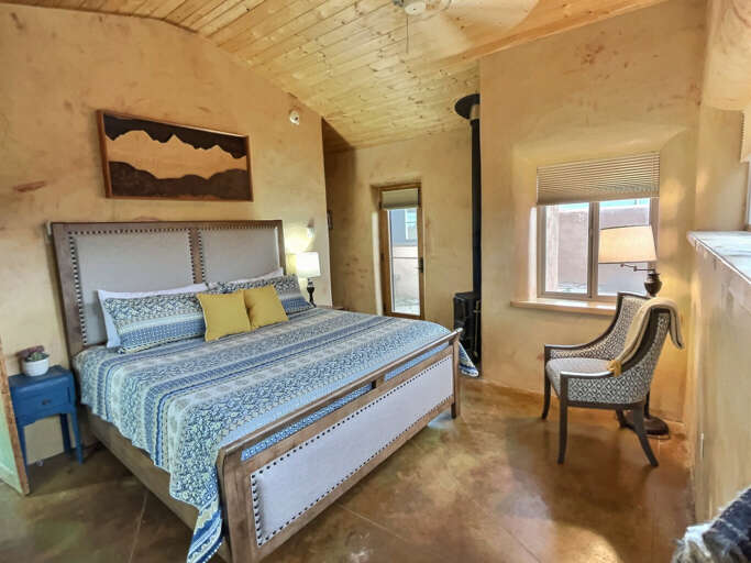 King bedroom with woodstove