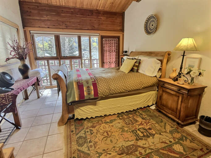 The most lovely queen bedroom with private deck with seating.