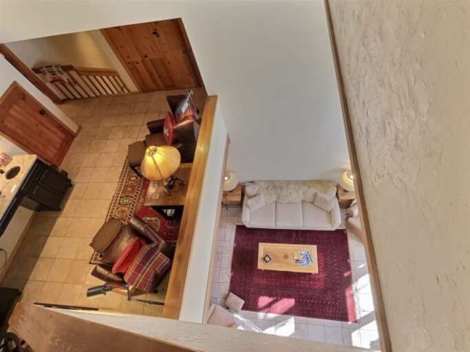 Tiered design means you can see downstairs from the third level and the warmth of the fireplace radiates through the whole home