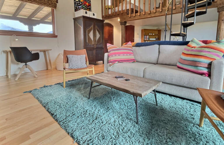 Cozy Entertainment area with large flat screen TV, fireplace, work desk